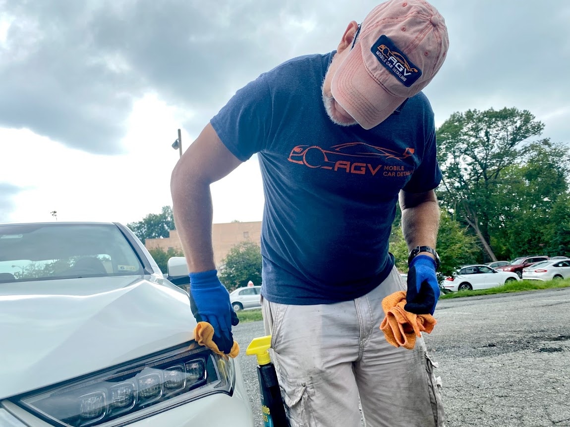 AGV Mobile Car Detailing — Alberto detailing a white car wearing AGV branded apparel
